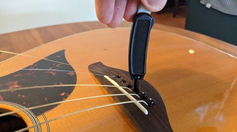How to Restring an Acoustic Guitar - remove bridge pins with a tool